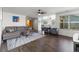 Bright living room featuring hardwood floors, a modern ceiling fan, and an open layout at 2430 E 109Th Dr, Northglenn, CO 80233