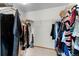Walk-in closet with hanging racks and ample space for storage, plus a vacuum cleaner at 2430 E 109Th Dr, Northglenn, CO 80233