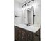 Bathroom features a wooden vanity, modern mirror, and sleek fixtures at 14850 Munich Ave, Parker, CO 80134
