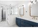 Modern bathroom with dual vanities, gold hardware, and luxurious walk-in shower with hexagon tiling at 14850 Munich Ave, Parker, CO 80134