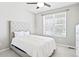 Neutral bedroom featuring a plush bed, white dresser, and large window offering natural light at 14850 Munich Ave, Parker, CO 80134