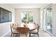 Bright dining room with a round wooden table, stylish chairs, and large windows at 14850 Munich Ave, Parker, CO 80134