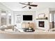Modern living room with a sleek fireplace, contemporary decor, and ample natural light at 14850 Munich Ave, Parker, CO 80134