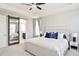Bright main bedroom with a ceiling fan and ensuite bathroom featuring a sliding barn door at 14850 Munich Ave, Parker, CO 80134