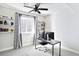 Bright home office space featuring a ceiling fan, built-in shelving, and large windows at 14850 Munich Ave, Parker, CO 80134