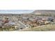 Scenic aerial view showcases a vibrant neighborhood nestled against rolling hills and distant mountains at 19760 W 59Th Dr, Golden, CO 80403