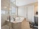 Bathroom showcasing a glass enclosed shower, soaking tub, tile flooring, and a dark vanity at 19760 W 59Th Dr, Golden, CO 80403