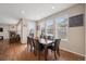 Bright dining room with hardwood floors, big windows, and a wooden table perfect for Gathering meals at 19760 W 59Th Dr, Golden, CO 80403