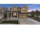 Charming two-story home featuring a two-car garage, covered porch, and manicured front lawn at dusk at 19760 W 59Th Dr, Golden, CO 80403