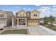 Charming two-story home featuring a two-car garage, covered porch, and manicured front lawn at 19760 W 59Th Dr, Golden, CO 80403