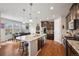 Bright and open kitchen with a large island, stainless appliances, and stylish pendant lighting at 19760 W 59Th Dr, Golden, CO 80403