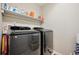 Laundry room featuring modern washer and dryer, plus upper shelf for storage at 19760 W 59Th Dr, Golden, CO 80403