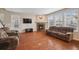 Inviting living room featuring a fireplace, hardwood floors, and large windows at 19760 W 59Th Dr, Golden, CO 80403