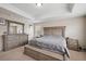 Main bedroom with neutral walls, trey ceiling, comfortable bed and ample natural light at 19760 W 59Th Dr, Golden, CO 80403