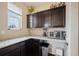 Charming pantry featuring granite countertops, wooden cabinetry, and modern appliances for convenient storage at 19760 W 59Th Dr, Golden, CO 80403
