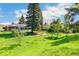 Expansive backyard with lush greenery, mature trees, and ample space for recreation at 12046 W Green Mountain Dr, Lakewood, CO 80228