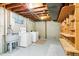 Unfinished basement with laundry area and ample storage space with exposed wooden beams at 12046 W Green Mountain Dr, Lakewood, CO 80228
