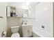 Bright bathroom features a tub/shower combo, white vanity, and mirrored medicine cabinet at 12046 W Green Mountain Dr, Lakewood, CO 80228