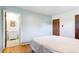 Bright bedroom featuring hardwood floors and easy access to a clean bathroom with a standup shower at 12046 W Green Mountain Dr, Lakewood, CO 80228