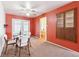 Dining room with red accent wall, carpeted floors, seating for four, and a built in cabinet at 12046 W Green Mountain Dr, Lakewood, CO 80228