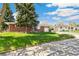 Charming home with a well-manicured lawn, mature trees, and a welcoming exterior at 12046 W Green Mountain Dr, Lakewood, CO 80228