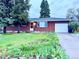 Charming brick home with a well-manicured front yard and mature trees, plus an attached garage at 12046 W Green Mountain Dr, Lakewood, CO 80228
