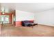 Neutral living room featuring carpeted floors, a large window and a cozy couch at 12046 W Green Mountain Dr, Lakewood, CO 80228