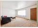 Neutral living room with carpeted floors and large window, and a view of the front door at 12046 W Green Mountain Dr, Lakewood, CO 80228