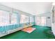 Bright sunroom with lots of natural light, vibrant green carpet, and a cheerful yellow table set at 12046 W Green Mountain Dr, Lakewood, CO 80228