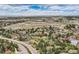 Scenic aerial view of a community with houses dotting the landscape, open fields, and picturesque sky at 8687 N Pinery Pkwy, Parker, CO 80134