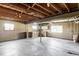 Spacious unfinished basement, featuring an open layout with exposed beam ceiling, large windows, and concrete flooring at 8687 N Pinery Pkwy, Parker, CO 80134