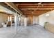 Unfinished basement with exposed ceiling, water heater, and utility connections, offering customization potential at 8687 N Pinery Pkwy, Parker, CO 80134