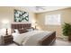This is a staged bedroom with stylish decor, a ceiling fan, a large window and wood furniture at 8687 N Pinery Pkwy, Parker, CO 80134