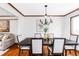 Dining room featuring dark wood table and chairs, chandelier, and hardwood floors at 8687 N Pinery Pkwy, Parker, CO 80134