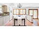 Bright dining room with hardwood floors, a modern chandelier and a view to kitchen at 8687 N Pinery Pkwy, Parker, CO 80134