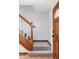 Entryway featuring a staircase with wooden banister and access to the front door at 8687 N Pinery Pkwy, Parker, CO 80134