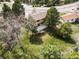 Aerial shot of a tan two-story home with a large deck, patio, and a well-maintained lawn at 8687 N Pinery Pkwy, Parker, CO 80134