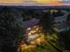 Aerial view of the home showing the back deck and patio illuminated in the evening at 8687 N Pinery Pkwy, Parker, CO 80134