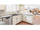 Bright eat-in kitchen featuring light countertops, cabinets, and an open view into the living room at 8687 N Pinery Pkwy, Parker, CO 80134