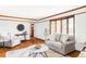 Bright living room with wood trim, hardwood floors, and neutral-colored furniture at 8687 N Pinery Pkwy, Parker, CO 80134
