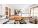 Spacious open living area with hardwood floors, lots of natural light, and open kitchen access at 8687 N Pinery Pkwy, Parker, CO 80134