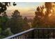 Scenic mountain view at sunset from the balcony with foreground trees creating a serene outdoor space at 8687 N Pinery Pkwy, Parker, CO 80134