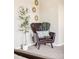 Inviting reading nook with a leather chair, throw, and a tree beside the chair at 8687 N Pinery Pkwy, Parker, CO 80134