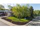 Corner lot home featuring mature trees, lush lawn, mulch beds, privacy fence and fire hydrant at 10909 W 65Th Way, Arvada, CO 80004