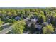 An aerial view shows the neighborhood with tree-lined streets and a mix of home styles at 10909 W 65Th Way, Arvada, CO 80004