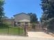 Spacious backyard with deck, fence, and mature trees at 10909 W 65Th Way, Arvada, CO 80004