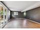 Open basement area with hardwood floors and access to the outdoors at 10909 W 65Th Way, Arvada, CO 80004