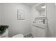 Half bathroom featuring black-and-white patterned tile and modern fixtures at 10909 W 65Th Way, Arvada, CO 80004
