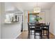 Inviting dining room with modern chandelier, dining set, and sliders to the back yard at 10909 W 65Th Way, Arvada, CO 80004