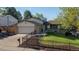 Charming home featuring a well-manicured lawn and garden beds with lovely curb appeal at 10909 W 65Th Way, Arvada, CO 80004